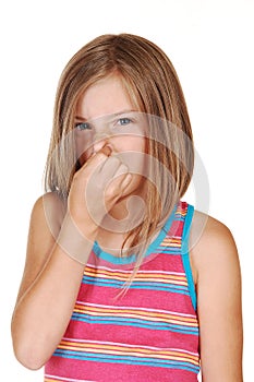 Girl holds her nose closed.