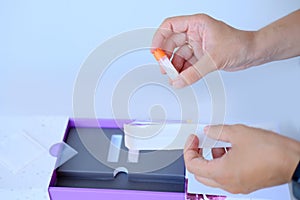 Girl holds a kit for a dna test in a box, a cotton swab for scraping the epithelium, collecting a genetic sample for analysis, the