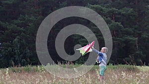 The girl holds a kite in her hands and launches it.Children's outdoor activities