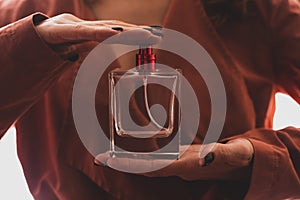 Girl holds perfume