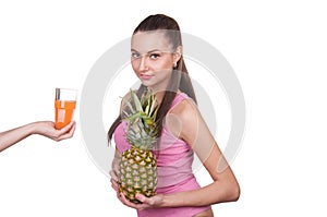 The girl holds pineapple