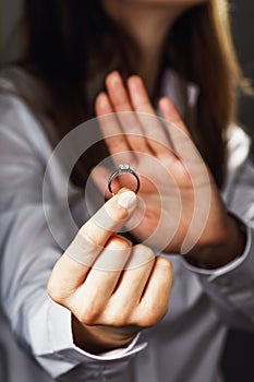 Girl holds a ring with diamond. Concept on refusal in an engagement