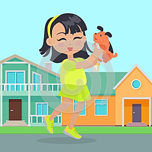 Girl Holds Small Dog in Hands in Front of Houses