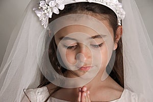 Girl in Holy Communion Dress praying