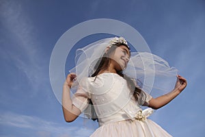 Girl in Holy Communion Dress and veil