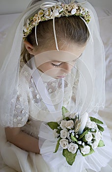 Girl in holy communion dress and veil