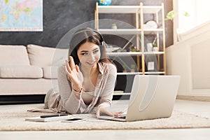 Girl at home communicating on skype in internet photo