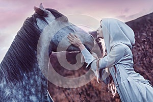 Girl in the hooded cloak with horse, effect of