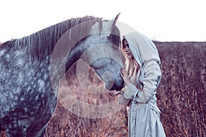 Girl in the hooded cloak with horse, effect of toning