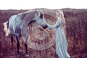 Girl in the hooded cloak with horse, effect of toning