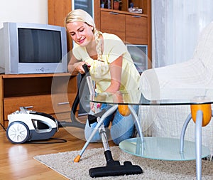 Girl hoovering in living room