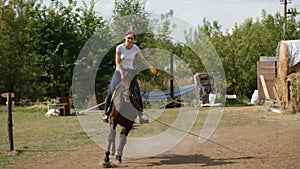 Girl on horse receives lesson of horse riding - equestrian sport, slow-motion