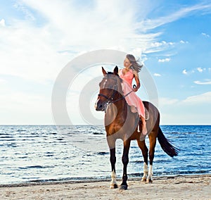 Girl with horse on seacoast