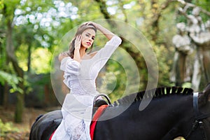 A girl on a horse straightens her hair.