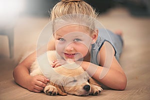 Girl hug her puppy in portrait, relax at home and happy with sleeping golden retriever and child with smile. Happiness