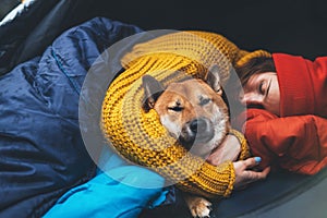 Girl hug resting dog together in campsite, close up red shiba inu sleeping in camp tent  trip, hiker woman leisure with friend