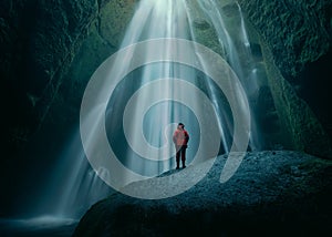 Girl on huge rock in Gljufrabui waterfall at south Iceland