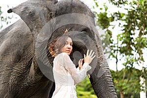 Girl hugging an elephant in the jungle