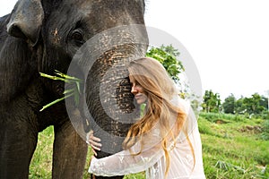 Girl hugging an elephant in the jungle