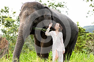 Girl hugging an elephant in the jungle