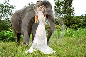 Girl hugging an elephant in the jungle