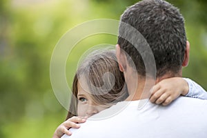 Girl hugging her father. Happy loving family. Dad and his daughter playing. Cute baby and daddy. Concept of Father day