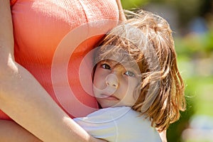 Girl hugging mather in the park