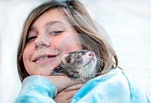 Girl hugging a  pet ferret
