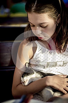 Girl hugging a stray kitten