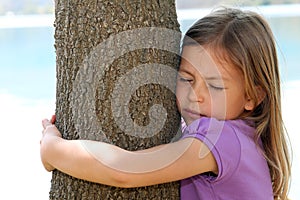 Girl hugging tree