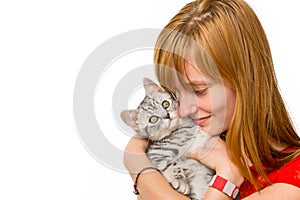 Girl hugging young silver tabby cat