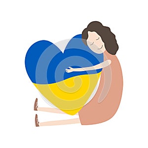 The girl hugs a big heart with the colors of the flag of Ukraine. Love Ukraine concept. Support for Ukraine. No war