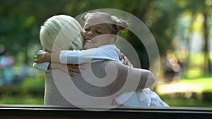 Girl hugs granny sitting on bench, sincere love for relatives trusting relations