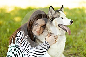 The girl hugs her beloved pet. Husky dog and its owner