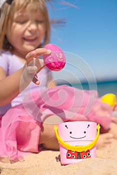 Girl hunting for easter eggs on the beach