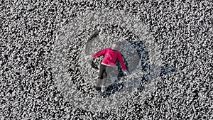 Girl ice skating roll on a frozen huge pond. View from above. Snc with a quadcopter