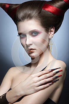 The girl in an image of the demon-tempter with long nails and haircut in the form of horns.