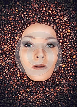 Girl immersed in coffee beans photo