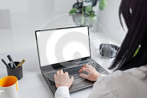 Girl immersed in her tasks on a laptop with an isolated screen for mockup