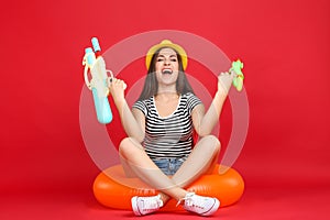 Girl with inflatable ring and water guns