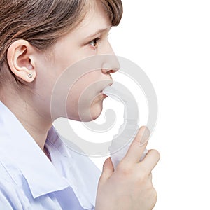 Girl inhales with mouthpiece of jet nebulizer