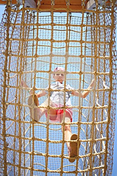 The girl inside the cable cell in playground,