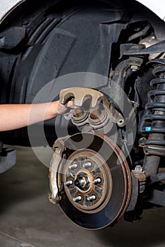 Girl inspects the calipers of a break from a pickup