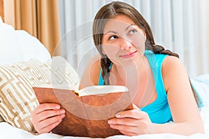 Girl with an interesting novel in bed