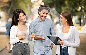 Girl Interviewing Young Couple Conducting Sociological Survey Standing Outdoor