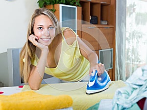 Girl ironing at home