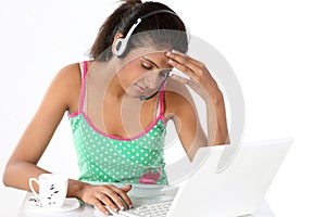 Girl irritating with laptop and headphones