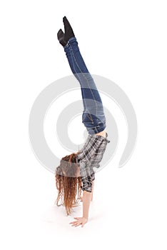 Girl in jeans doing acrobatic stunt