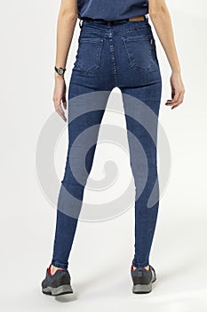 girl in jeans shows off jeans on white background close up