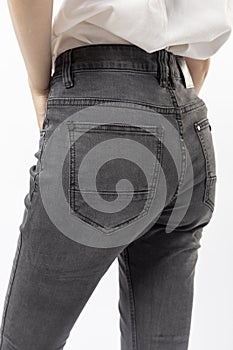 girl in jeans shows off jeans on white background close up